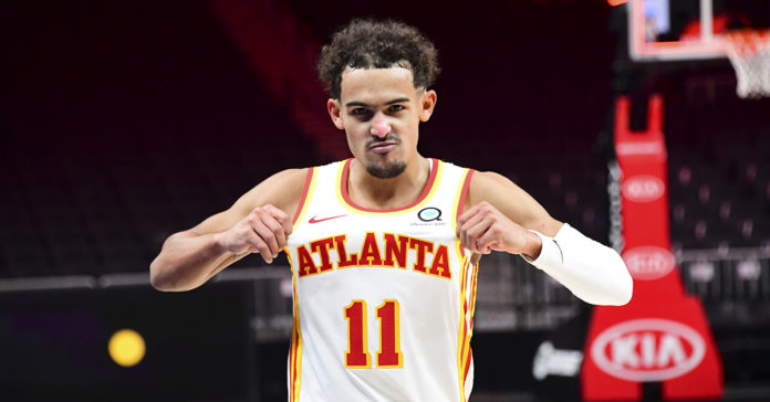 Hawks' star Trae Young celebrating his team jersey.