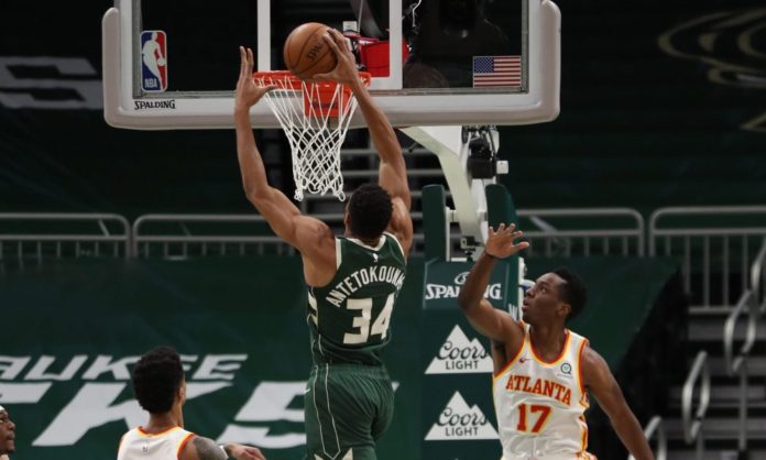 Bucks' star Giannis heading to the rim for a slam dunk.