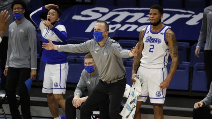 Drake basketball players celebrating on the bench.