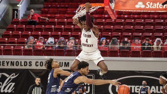 An Eastern Kentucky basketball player slam-dunking.