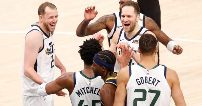 Utah Jazz members celebrating together.