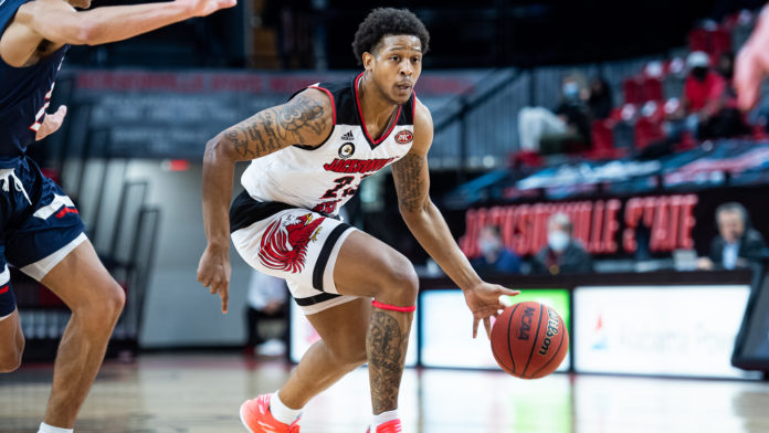 Jacksonville State basketball player Darian Adams dribbling down the court.