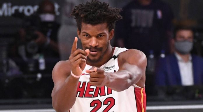 Miami Heat star Jimmy Butler celebrates with a little pistol-shooting hand gestures.