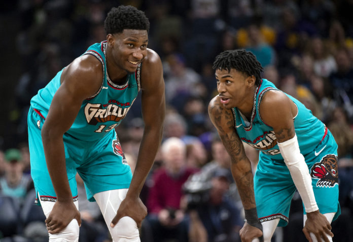 Ja Morant and his teammate hanging out during a game.