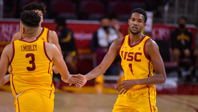 USC Basketball players celebrating together on the court.