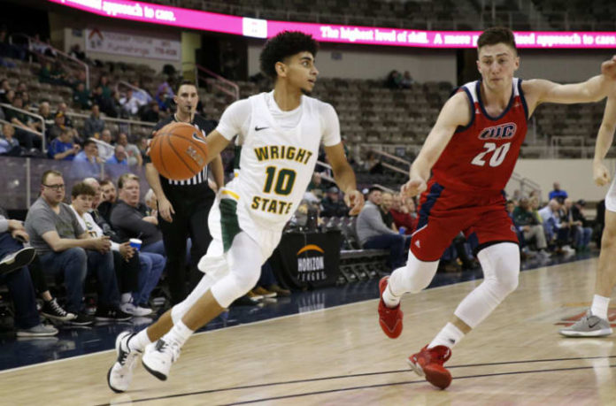 A Wright State player dribbling the court.