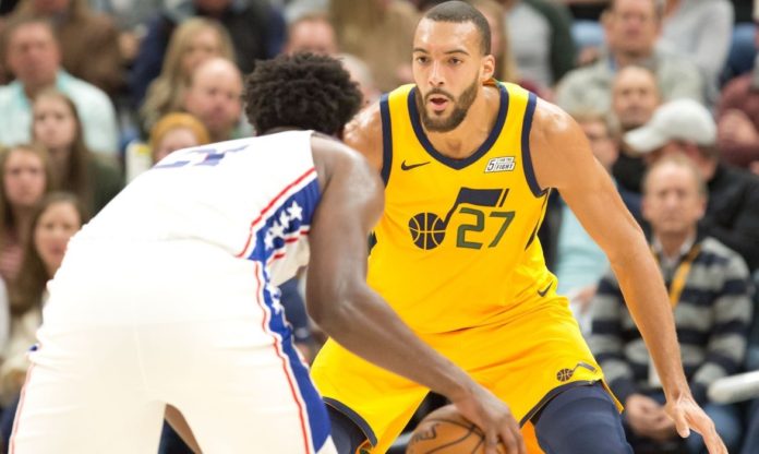 76ers star Joel Embiid posting up against Rudy Gobert.