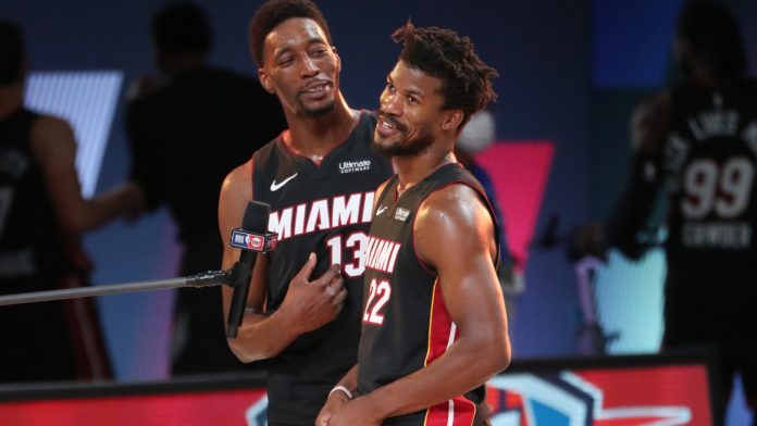 Heat stars Bam Adebayo and Jimmy Butler embracing during a game.