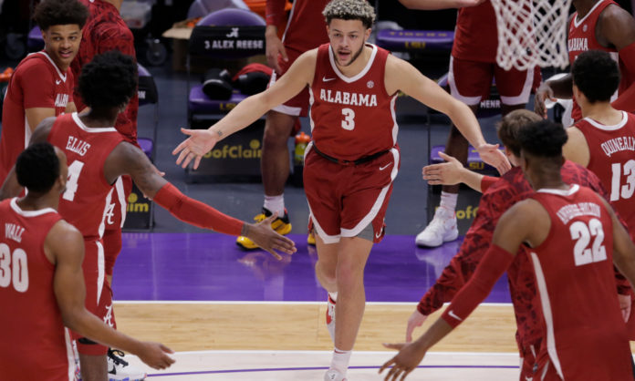 Alabama forward Alex Reese (3) slaps hands with teammates as he is introduced before Alabama's NCAA college basketball game against LSU in Baton Rouge, La., Tuesday, Jan. 19, 2021.