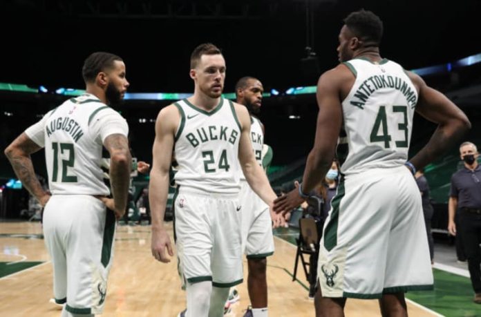 The Milwaukee Bucks huddled together on the sideline.