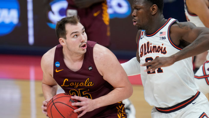 Loyola Chicago center Cameron Krutwig (25) drives on Illinois center Kofi Cockburn (21) during the second half of a men's college basketball game in the second round of the NCAA tournament at Bankers Life Fieldhouse in Indianapolis, Sunday, March 21, 2021. (AP Photo/Paul Sancya)