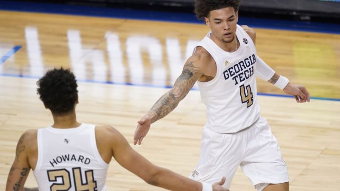 Georgia Tech basketball players celebrating after a made shot.