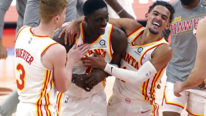 Atlanta Hawks players celebrating a last second bucket for the win.