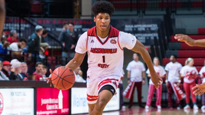 A Jacksonville St. guard dribbling down the court.