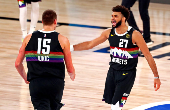 Sep 13, 2020; Lake Buena Vista, Florida, USA; Denver Nuggets guard Jamal Murray (27) reacts with center Nikola Jokic (15) during the fourth quarter against the LA Clippers in game six of the second round of the 2020 NBA Playoffs at ESPN Wide World of Sports Complex. Mandatory Credit: Kim Klement-USA TODAY Sports