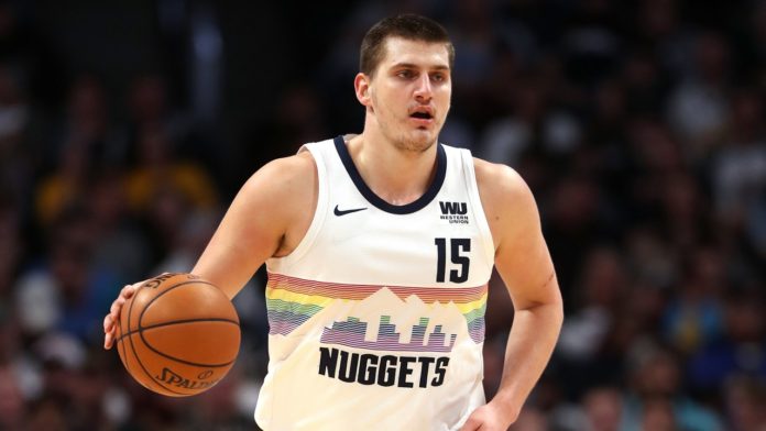 Nikola Jokic dribbling down the court.