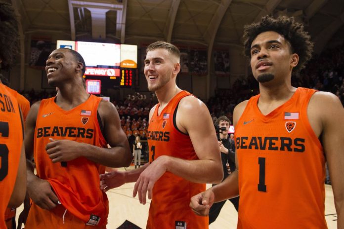 The Oregon State basketball team celebrating together after winning a tournament game.