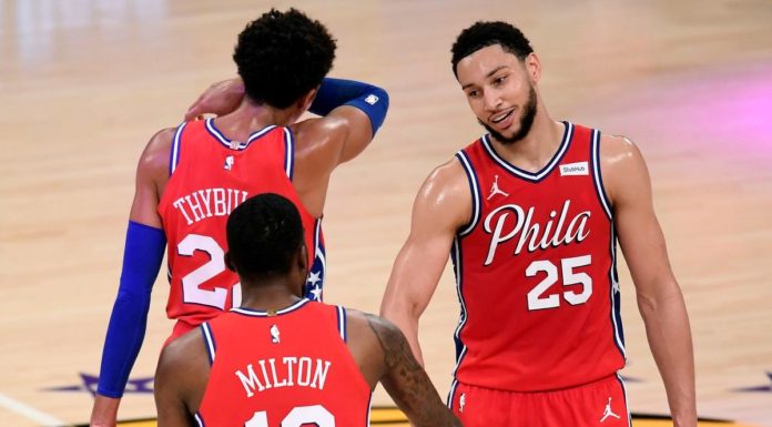 Philadelphia 76ers players shaking hands in celebration.