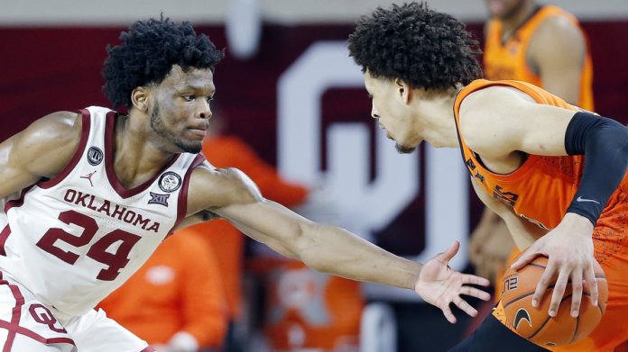 An Oklahoma defender squaring up against an Oklahoma State guard.