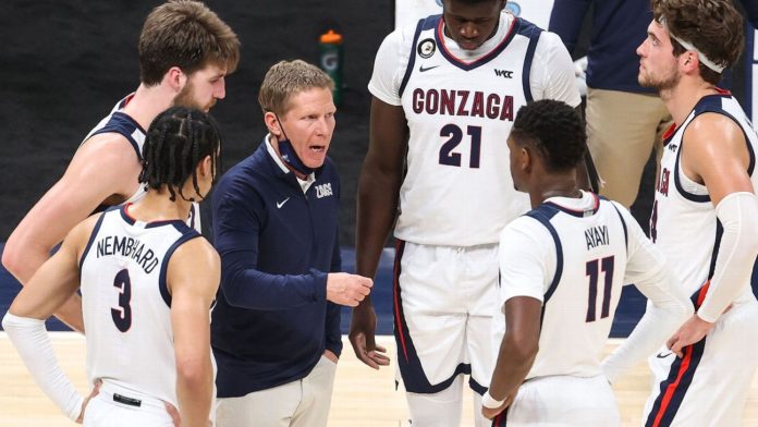 A picture of the Gonzaga Bulldogs basketball team getting coached on the bench.