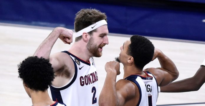 Gonzaga basketball teammates celebrating after a big win.