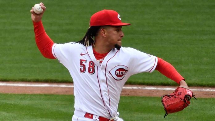 The Reds' Luis Castillo winding back for a pitch at the mound.