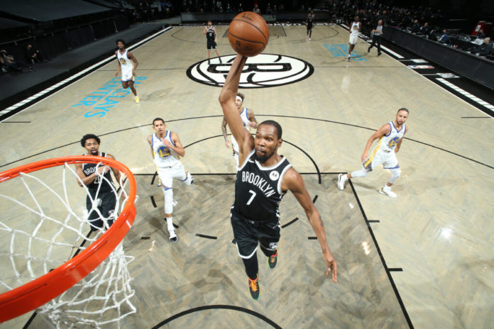 BROOKLYN, NY - DECEMBER 22: Kevin Durant #7 of the Brooklyn Nets dunks the ball during the game against the Golden State Warriors on December 22, 2020 at Barclays Center in Brooklyn, New York. NOTE TO USER: User expressly acknowledges and agrees that, by downloading and or using this Photograph, user is consenting to the terms and conditions of the Getty Images License Agreement. Mandatory Copyright Notice: Copyright 2020 NBAE (Photo by Nathaniel S. Butler/NBAE via Getty Images)