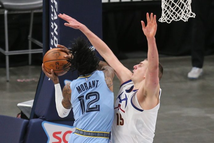 The Grizzlies and Nuggets battling on the court.