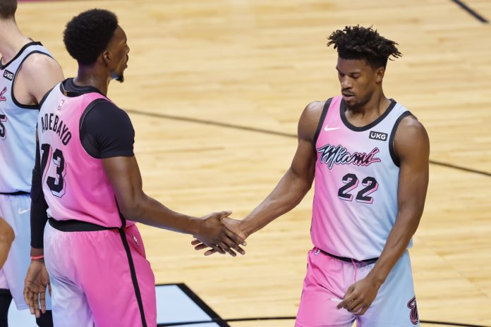 MIAMI, FLORIDA - JANUARY 04: Bam Adebayo #13 and Jimmy Butler #22 of the Miami Heat celebrate against the Oklahoma City Thunder during the third quarter at American Airlines Arena on January 04, 2021 in Miami, Florida. NOTE TO USER: User expressly acknowledges and agrees that, by downloading and or using this photograph, User is consenting to the terms and conditions of the Getty Images License Agreement. (Photo by Michael Reaves/Getty Images)