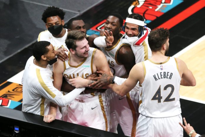 The Mavericks players celebrating after Luka's game winning shot.