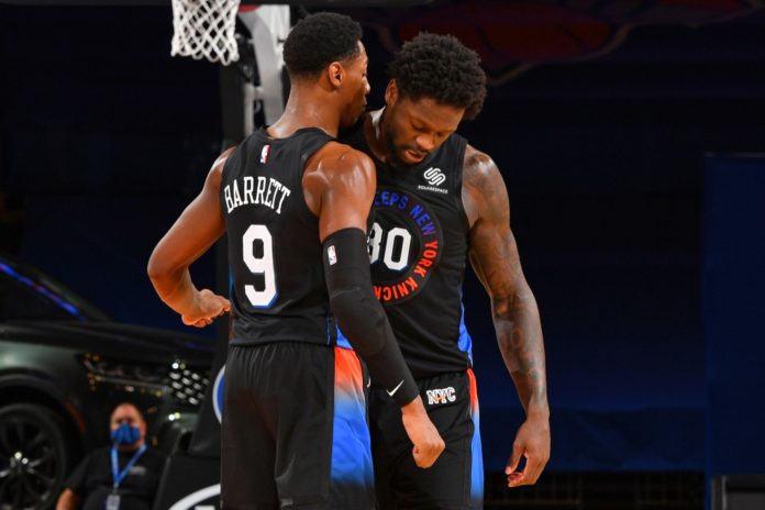 Knicks' stars RJ Barrett and Julius Randle discussing game-plans on the court.