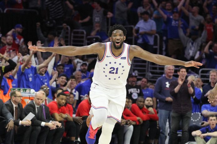 76ers star Joel Embiid celebrating after a big shot.