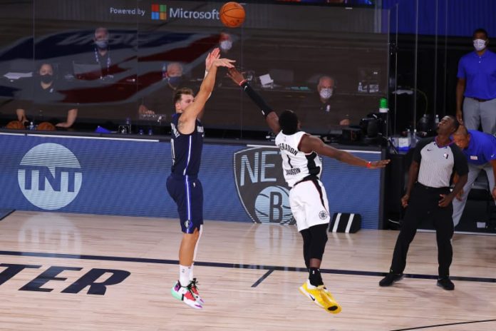 Luka Doncic launching a shot against the Nets.