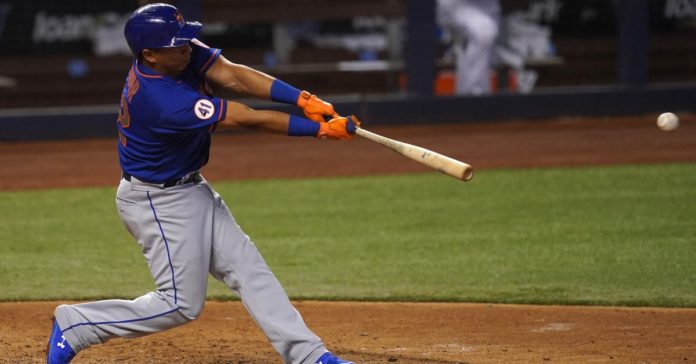 A New York Mets hitter at home plate, swinging for the fences.