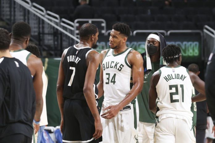 Bucks and Nets players squaring off on the hardwood.