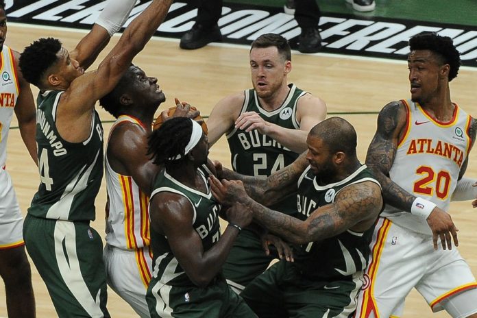 Hawks and Bucks player fighting for the ball in game 2 of the East Finals.