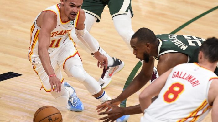 The Bucks and Hawks scrambling for the ball during a playoff game.