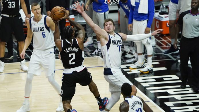 The Clippers and Mavericks fighting over the ball in game 5 of the Western Conference NBA playoffs.