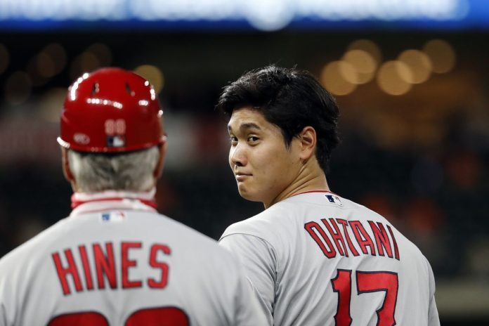 LAA Angels star, Shohei Ohtani, smirking at his coach.