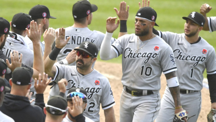 White Sox players high fiving each other after a win.