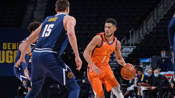 Suns and Nuggets players facing off on the hardwood.