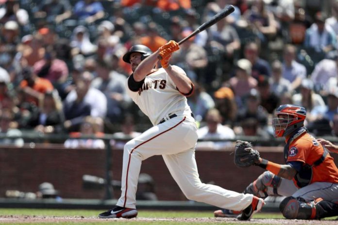 A Giants hitter, slugging a big homerun at the mound.