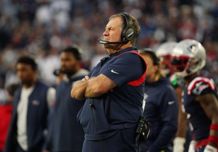 Bill Belichik standing on the sidelines.