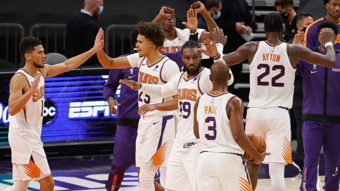 The Phoenix Suns, high-fiving during a game.