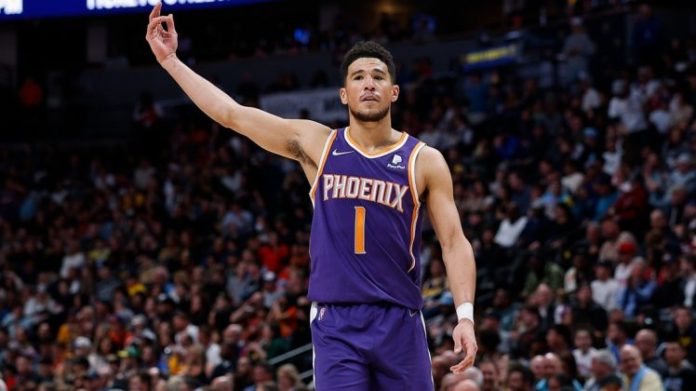 Devin Booker, celebrating on the hardwood.