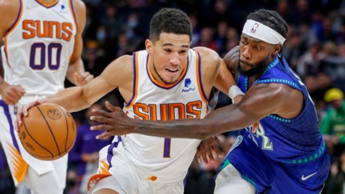 Devin Booker charging into the rim against Pat Beverly and the T-Wolves.